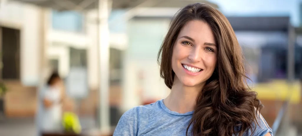 Woman smiling thanks to dental treatments from Sweet Tooth Smiles in Richmond and Memorial, Texas.